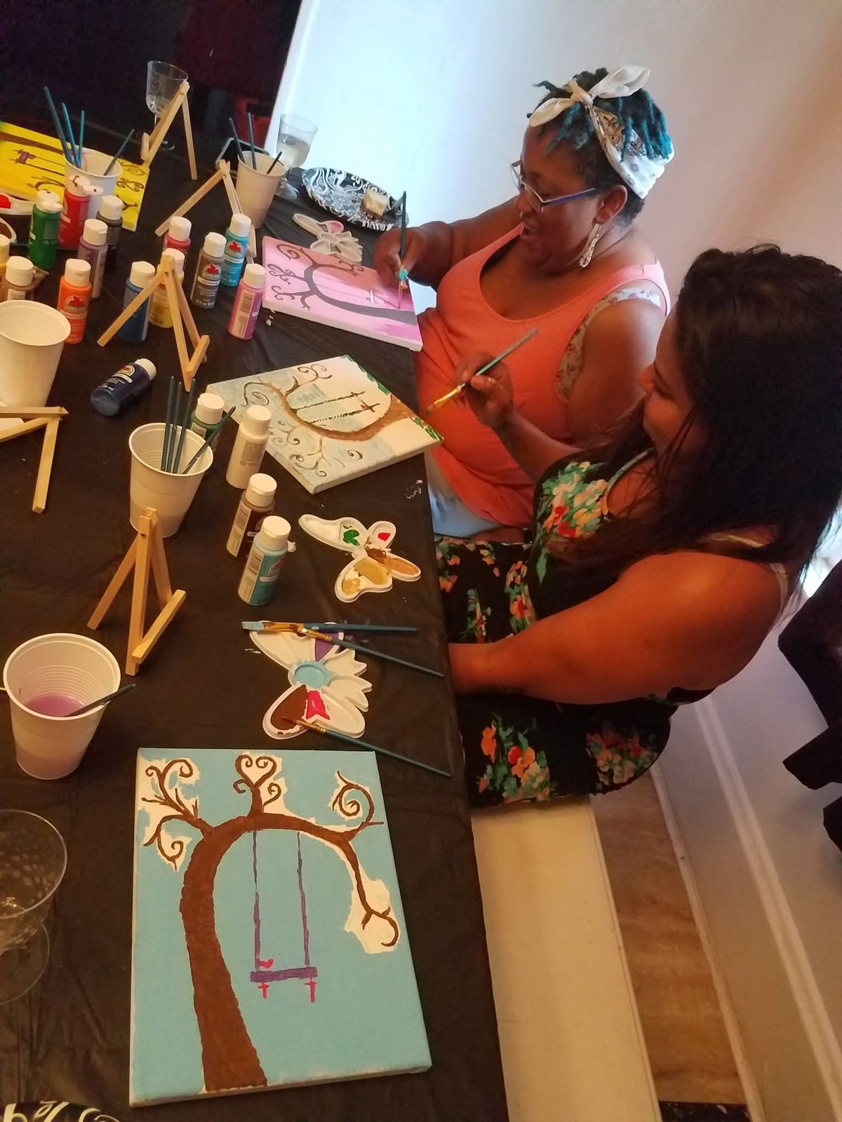 Women painting tree canvases at SHH paint night