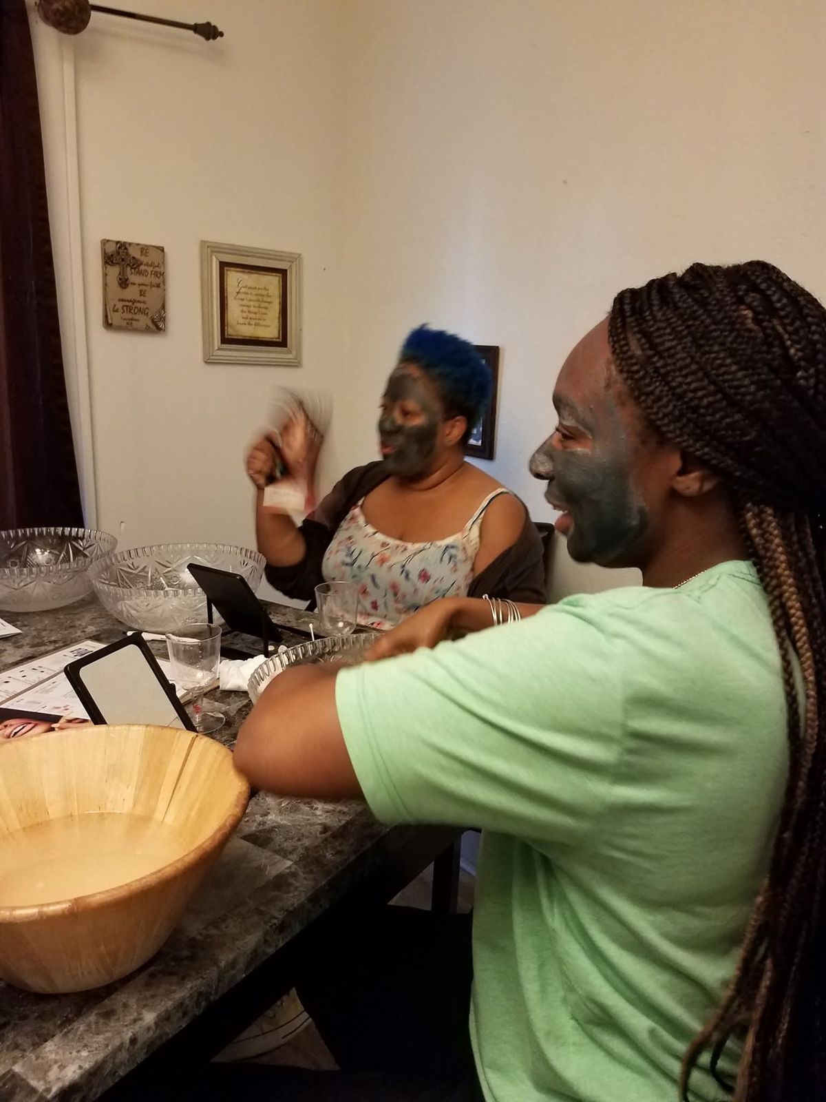 Women applying face masks together